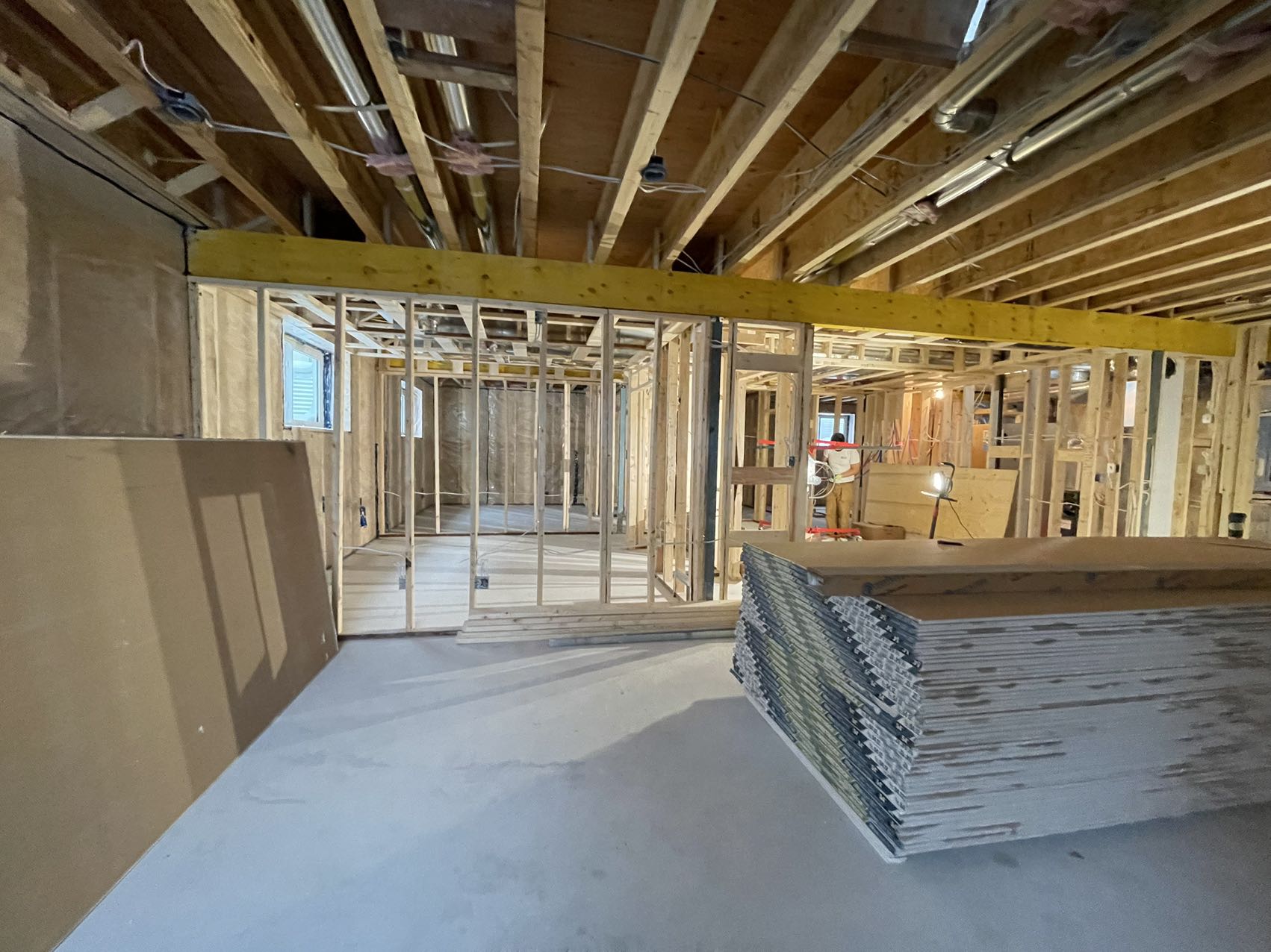 Technicians from ANR Drywall LTD are installing drywall boards in a client's basement.