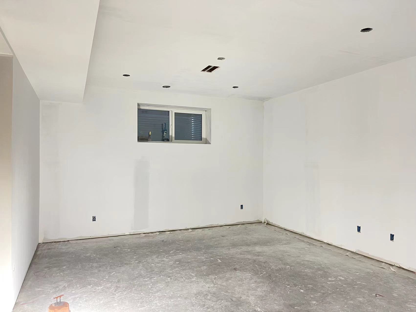 Technicians from ANR Drywall LTD are installing drywall boards in a client's basement.