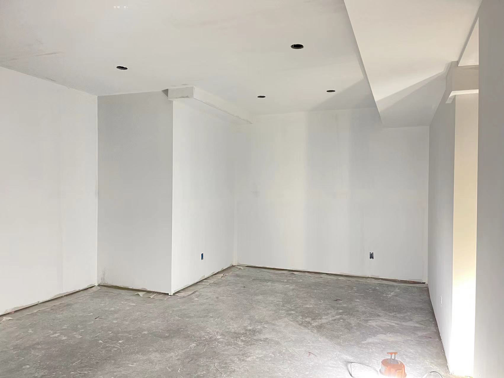 Technicians from ANR Drywall LTD are installing drywall boards in a client's basement.