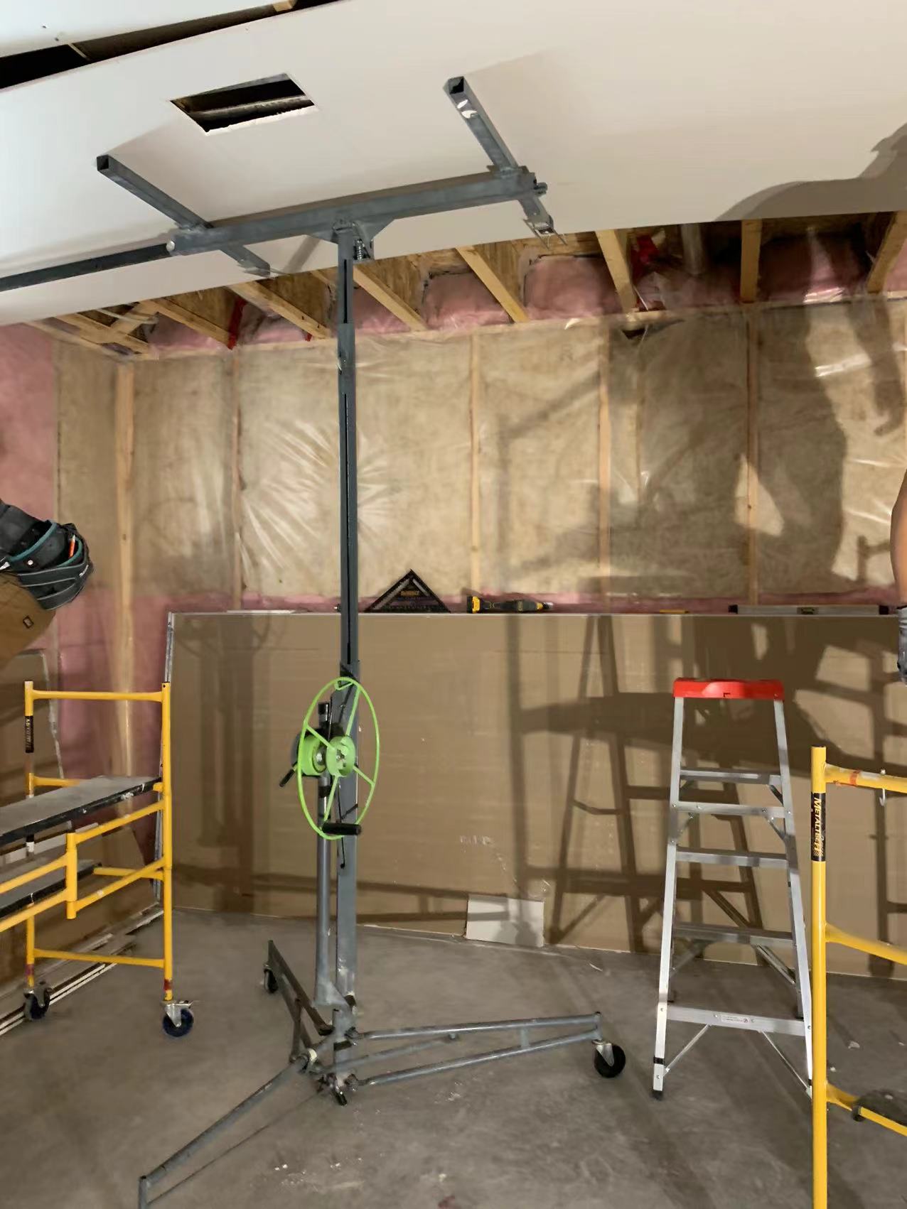 Technicians from ANR Drywall LTD are installing drywall boards in a client's basement.