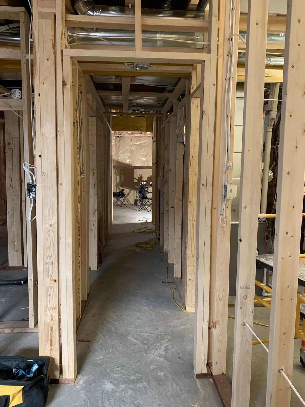 Technicians from ANR Drywall LTD are installing drywall boards in a client's basement.